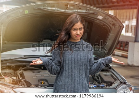 young stressed woman having trouble with his broken car need held in frustration at failed engine
