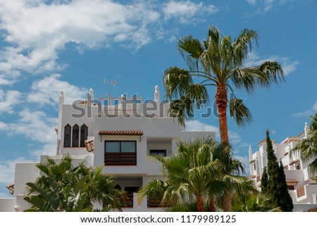 Сolorful buildings and palms A summer, holiday day on the in Spain..