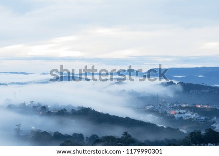 Fog cover town background with mountais and light. Pictures use for advertising, design, marketing or cover, wallpaper