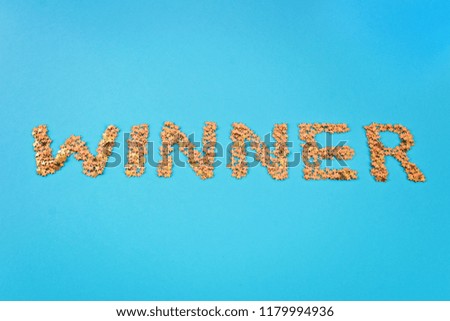 The word Winner is laid out of starry confetti on a blue background.