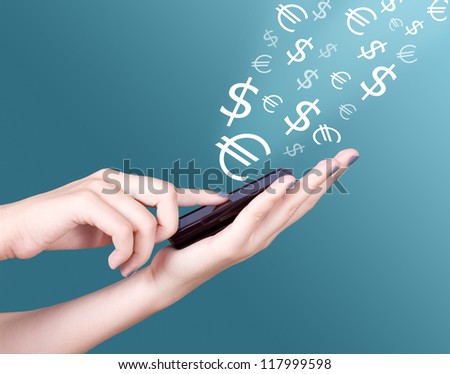 Hands holding modern mobile telephone, dollar and euro symbols flaying away. E-business concept
