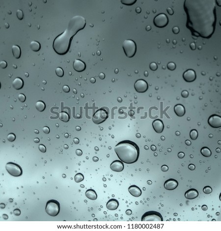 rain water droplets on the window on the background of dark rain clouds