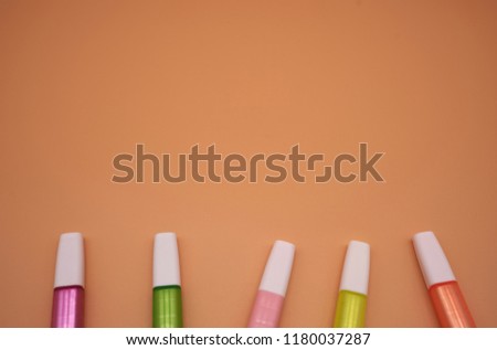 minimal highlighter pens on orange paper background            
