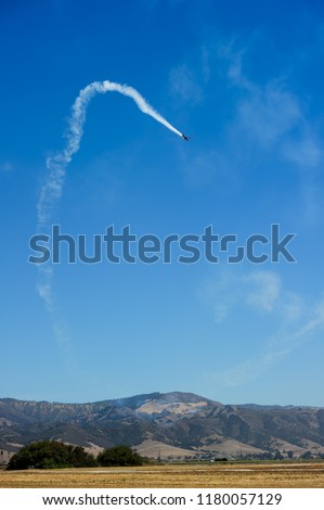 Airplanes show aerobatic performs flight on blue sky background.
