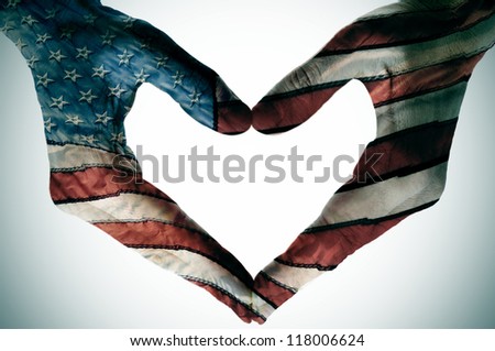 man hands painted as the american flag forming a heart
