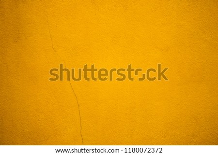 Closeup yellow wall textured using as background concept