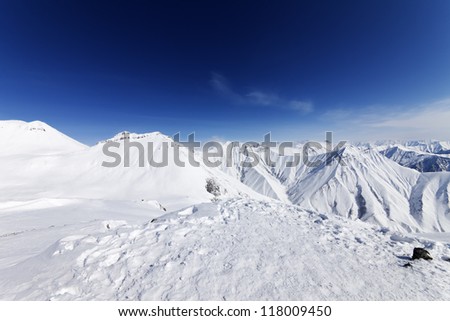 Winter snowy mountains and blue sky. Caucasus Mountains, Georgia, ski resort Gudauri.