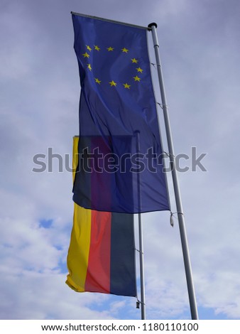 Flag of Europe along with flag of Germany. Transparent EU flag against German flag.
