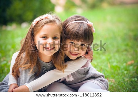 Happy little girlfriends in park Royalty-Free Stock Photo #118012852