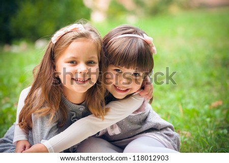 Happy little girlfriends in park Royalty-Free Stock Photo #118012903