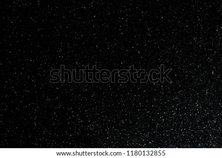 closeup background texture of snowflakes during a snowfall on a black background Royalty-Free Stock Photo #1180132855