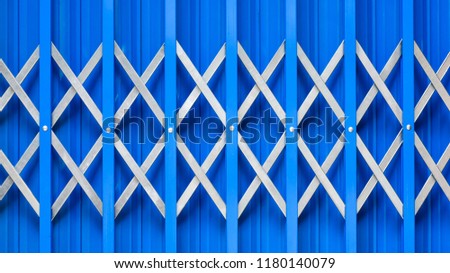 Close up to steel cage door on blue background view. Copy space. Flat lay design.