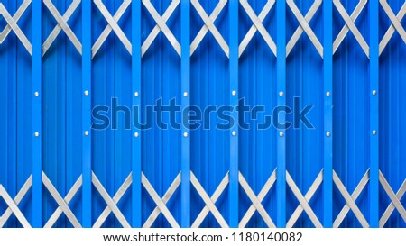 Close up to steel cage door on blue background view. Flat lay creative on copy space.