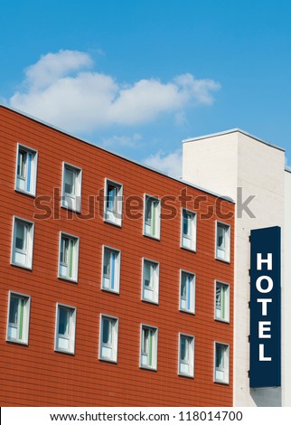 facade of a modern red brick Hotel building with sign