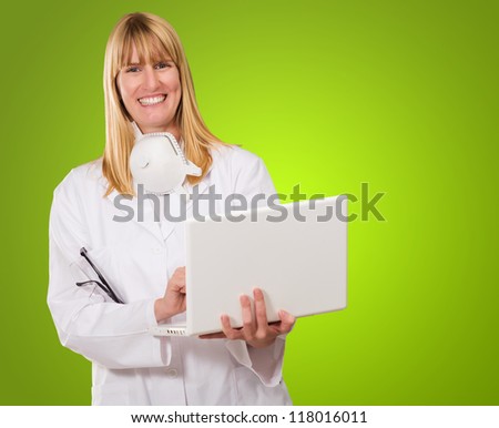 Female Doctor Using Laptop against a green background