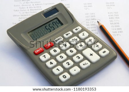 Calculator tool and financial report. Calculator and financial data.
