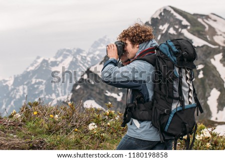 pleasant young tourist is using the digital camera while travelling.sights and lifestyle concept