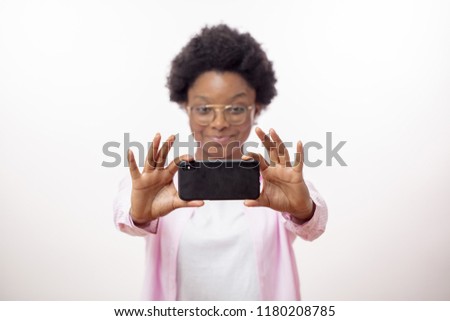 awesome smiling africaan hipster girl trying to make a good photo, isolated white background, close up portrait. blurred background.