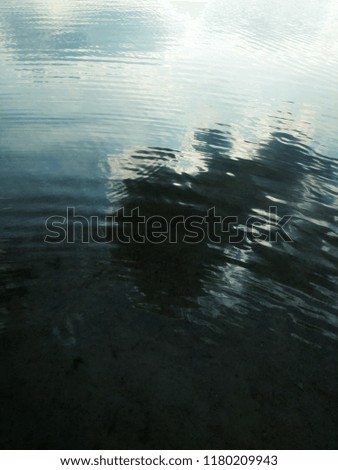 The clouds are displayed in the watery surface. Display in the thickness of water. Beautiful water reflection