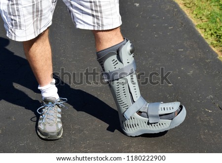 An orthopedic air boot on a man's leg. Royalty-Free Stock Photo #1180222900