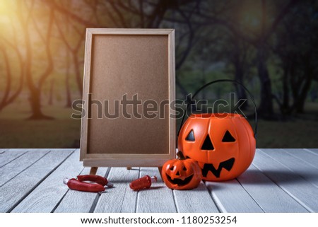 Halloween background. Spooky pumpkin, Black spider, chalkboard on white wooden floor with moon and dark forest. Halloween design with copyspace