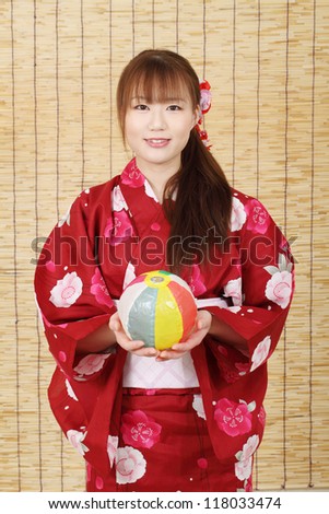 Young asian woman in traditional clothes of kimono with paper balloon