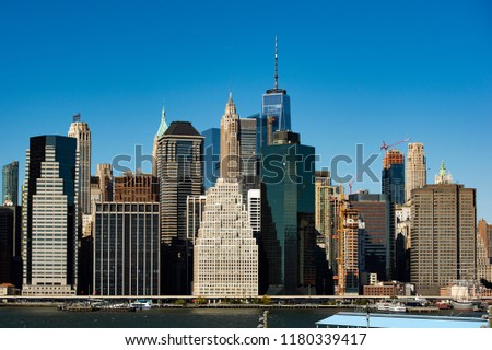 Amazing view of the Manhattan skyline seen from the Brooklyn Bridge Park. Sunny day of October in New York. USA. 