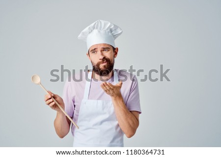 doubting chef with a wooden spoon                               