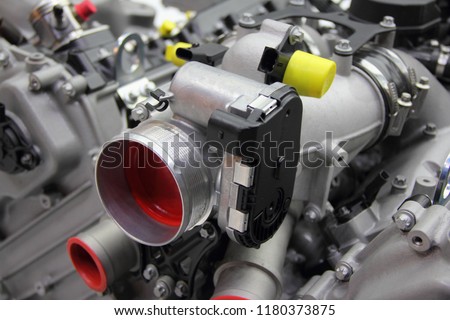 Model of new car V12 engine - throttle pipe with throttle position sensor and mass air flow sensor on motor block Royalty-Free Stock Photo #1180373875