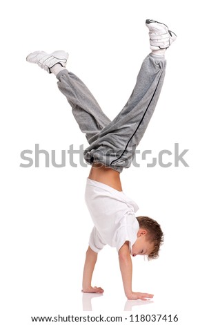 Happy little boy gymnastic acrobatics equilibrium posture isolated on white background