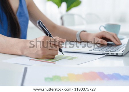 Business women using laptop and   analysis financial document
