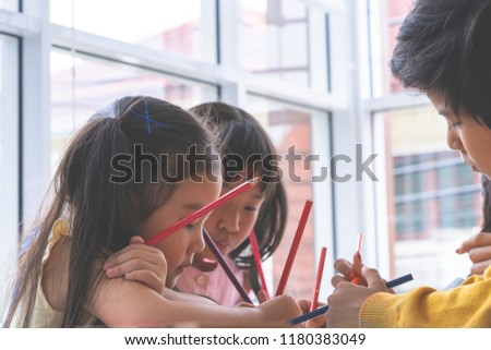 Asian girl is painting on paper in Art group