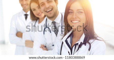 female doctor with group of happy successful colleagues Royalty-Free Stock Photo #1180388869