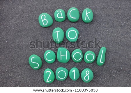 Back to School 2018, souvenir with green colored sea stones over black volcanic sand