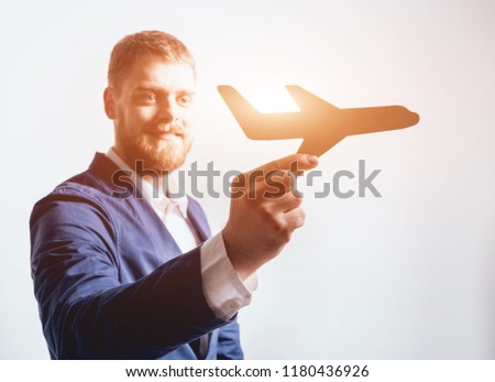 Man proposing signing a life insurance policy, the agent is holding the wooden plane model. Life insurance concept.