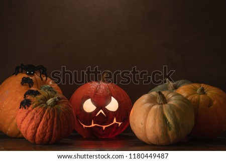 Spooky Halloween pumpkins on wooden planks with vintage background