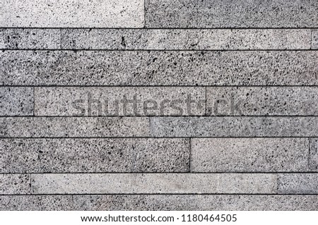 Abstract pattern on the surface of the briquette made of foamed concrete as a background. The cellular texture of the concrete.