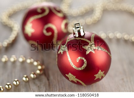 Red and golden Christmas decorations on wooden background