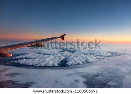 Airplane overflying the Khibiny Mountains in the Kola Peninsula in European Russia's Far North, over the Arctic Polar Circle. Picture taken from inside the plane.