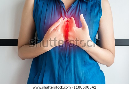 Asian woman having or symptomatic acid reflux,Gastroesophageal reflux or gerd disease,Because the esophageal sphincter that separates the esophagus and stomach dysfunction Royalty-Free Stock Photo #1180508542