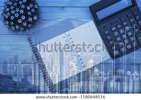 Double exposure of Office supplies or office work essential tools items on table with city background