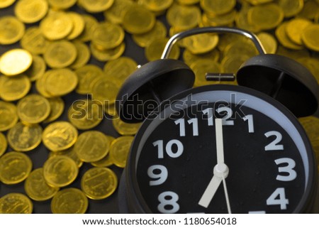 Alarm clock and coins stacks on working table, time for savings money concept, banking and business concept idea.