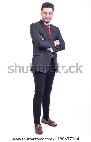 Businessman isolated in white background. Handsome young indian businessman in suit portrait, confident looks. Full length shot.