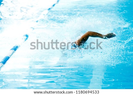 Image of man swimming in style of crawl in swimming pool