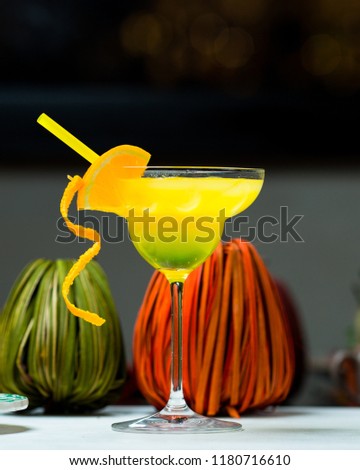 Exotic cocktails in rays of sun; fresh summer cold alcohol drinks