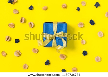 top view gift box wrapped with gold ribbon on yellow background
