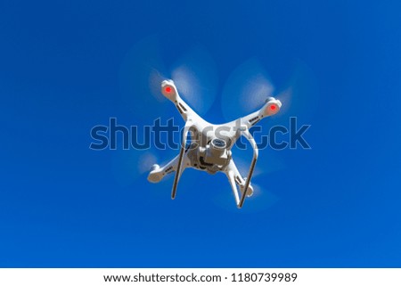 camera drone in front of blue sky taking pictures