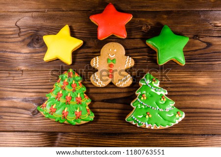 Different christmas gingerbread cookies on rustic wooden table. Top view