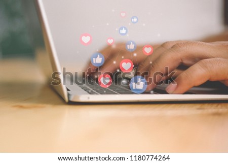 Hand using laptop with Social media concept.