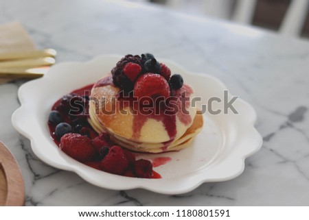 pancake with berry in white plate